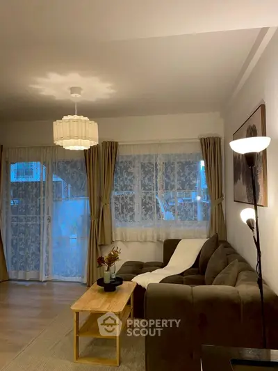 Cozy living room with stylish decor and ample natural light