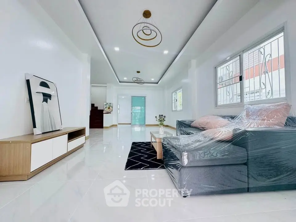 Spacious modern living room with sleek furniture and elegant lighting