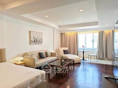 Spacious modern living room with elegant decor and large windows for natural light.