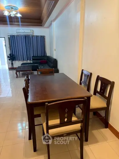 Spacious living room with dining area and comfortable seating, perfect for family gatherings.