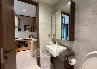 Modern bathroom with marble walls and sleek fixtures in luxury apartment