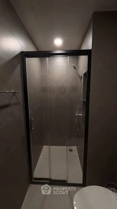 Modern bathroom with sleek glass shower enclosure and contemporary fixtures.