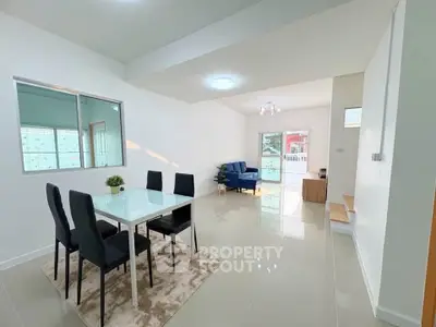 Spacious modern living and dining area with sleek furniture and natural light.