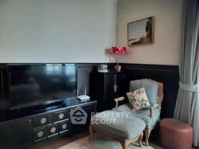 Charming living room with vintage armchair, TV, and elegant decor