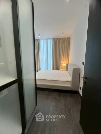 Modern bedroom with floor-to-ceiling windows and elegant decor