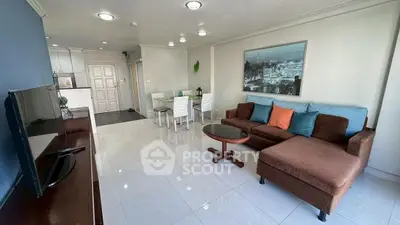 Spacious living room with modern decor and open kitchen layout