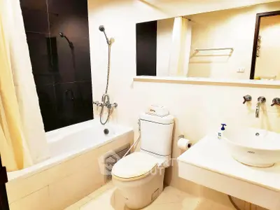 Modern bathroom with sleek fixtures and a bathtub in a stylish apartment.