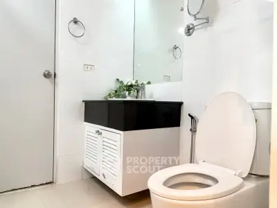 Modern bathroom with sleek fixtures and elegant vanity in a contemporary home.