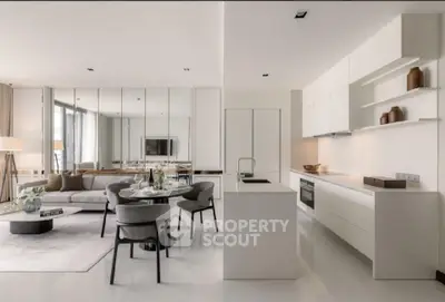Luxurious open-plan living room and kitchen with modern decor and sleek furnishings.