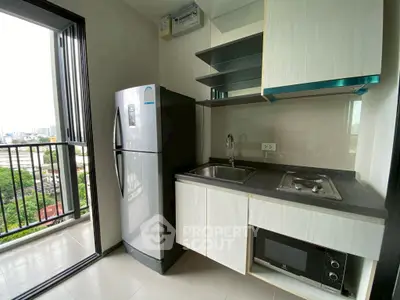 Modern kitchen with balcony view featuring sleek appliances and open shelving.