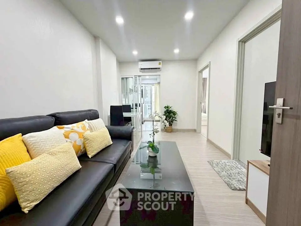 Modern living room with sleek design and cozy ambiance, featuring stylish furniture and bright lighting.