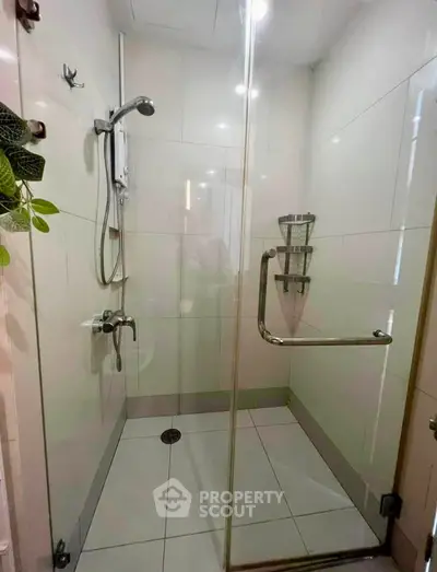 Modern bathroom with glass shower enclosure and sleek fixtures