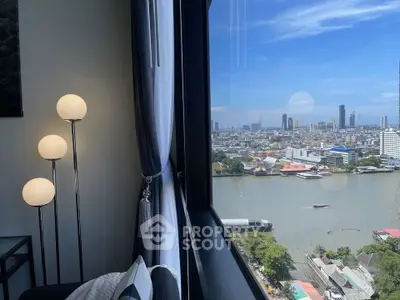 Stunning cityscape view from modern apartment with floor-to-ceiling windows and stylish decor.