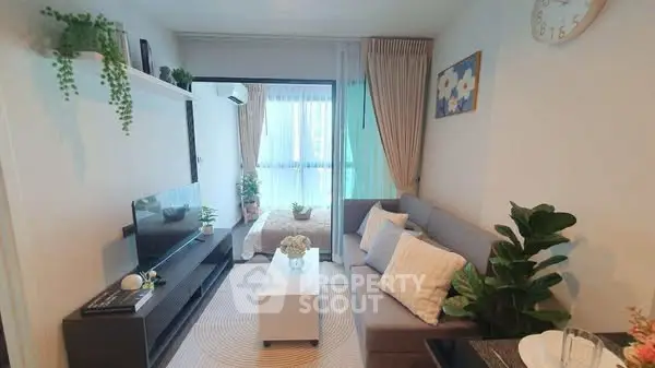 Modern living room with cozy sofa, TV, and elegant decor in a bright apartment.