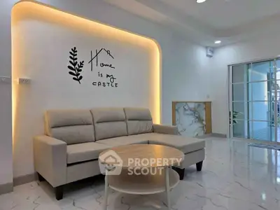 Modern living room with stylish sofa and elegant wall decor, featuring marble flooring and ambient lighting.