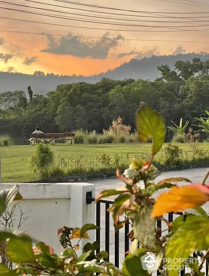 Scenic garden view with lush greenery and sunset backdrop