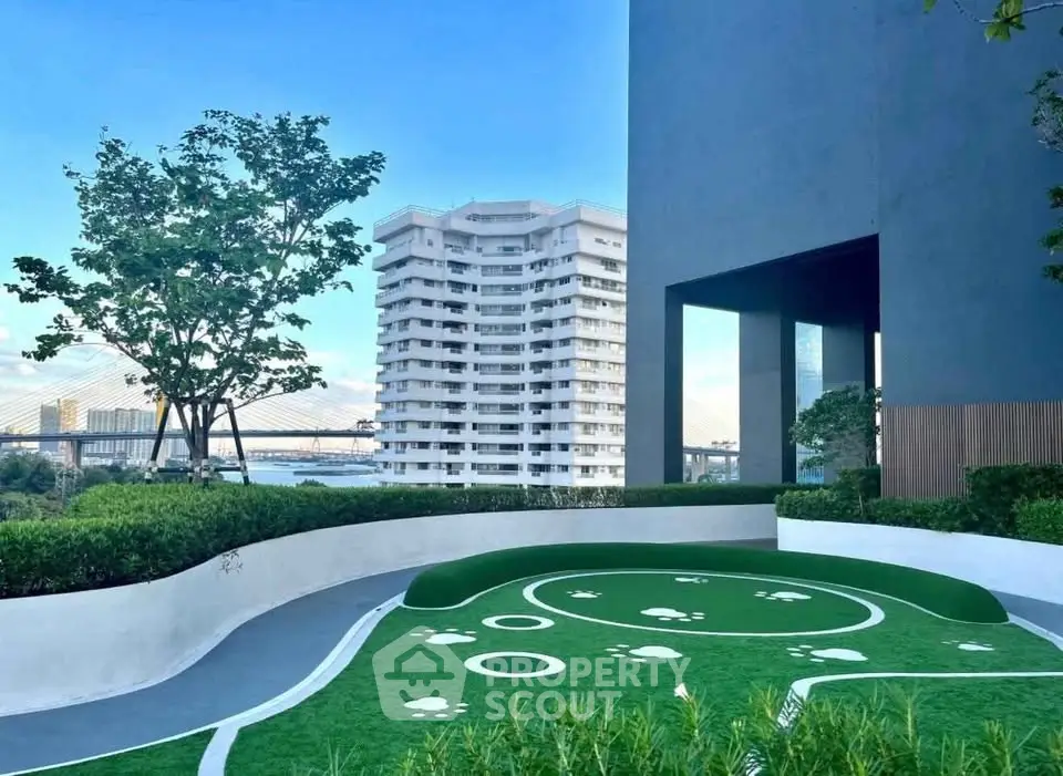 Modern building exterior with lush garden and city view, ideal for urban living.