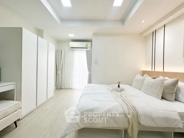 Spacious modern bedroom with elegant decor and natural light