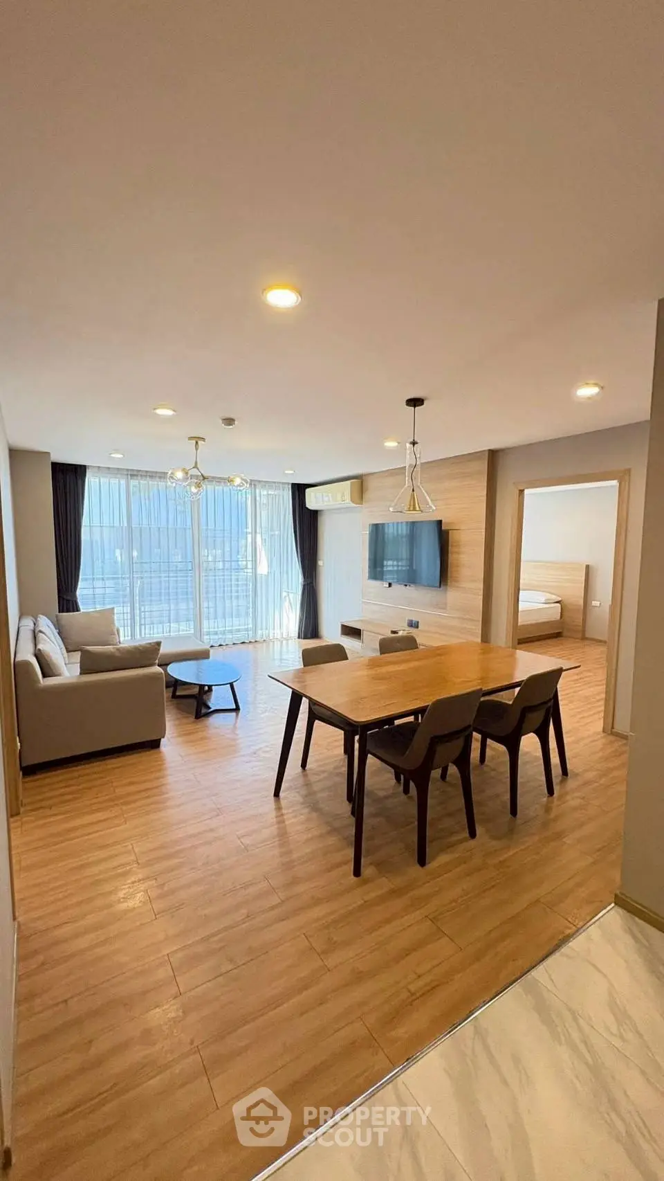 Spacious modern living room with dining area and large windows