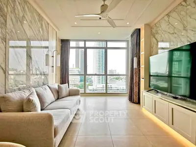 Luxurious living room with marble accents and city view, featuring modern furnishings and large TV.