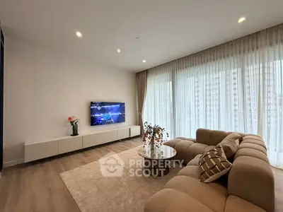 Spacious modern living room with large windows and elegant decor