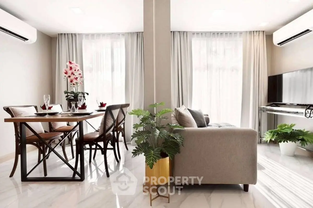 Modern open-plan living and dining area with stylish decor and natural light.