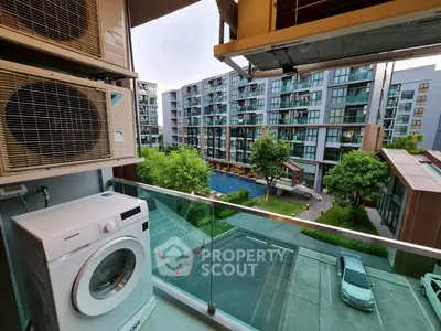 Modern apartment balcony with washing machine and pool view