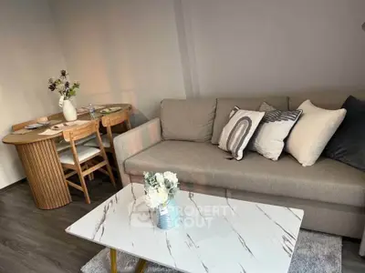 Stylish living room with modern sofa and chic dining area, perfect for cozy gatherings.