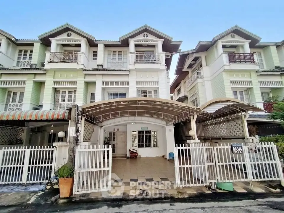 Charming multi-story townhouse with gated entrance and spacious driveway in a serene neighborhood.