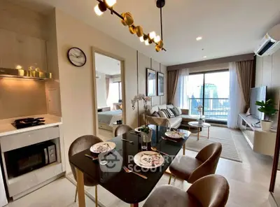 Modern open-plan living and dining area with city view balcony in luxury apartment.