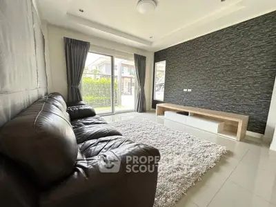 Spacious living room with modern decor and large window view