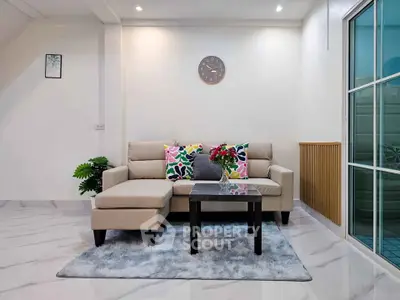 Stylish living room with modern sofa, vibrant cushions, and elegant decor in a cozy home setting.