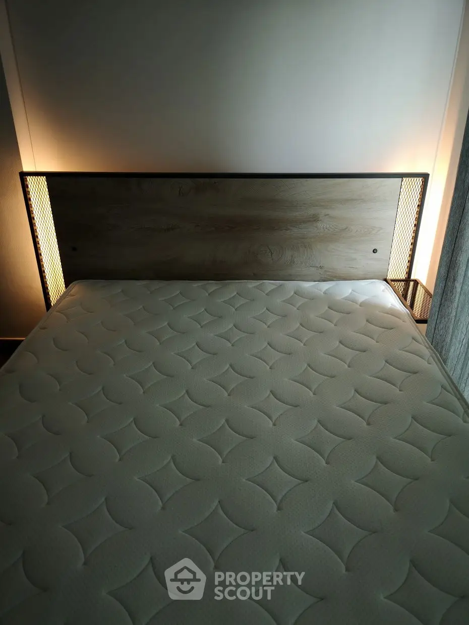 Modern bedroom with stylish headboard and ambient lighting