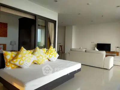 Spacious modern living room with stylish decor and comfortable seating.