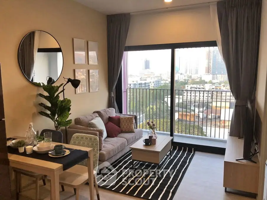 Modern living room with city view, stylish decor, and cozy seating area.