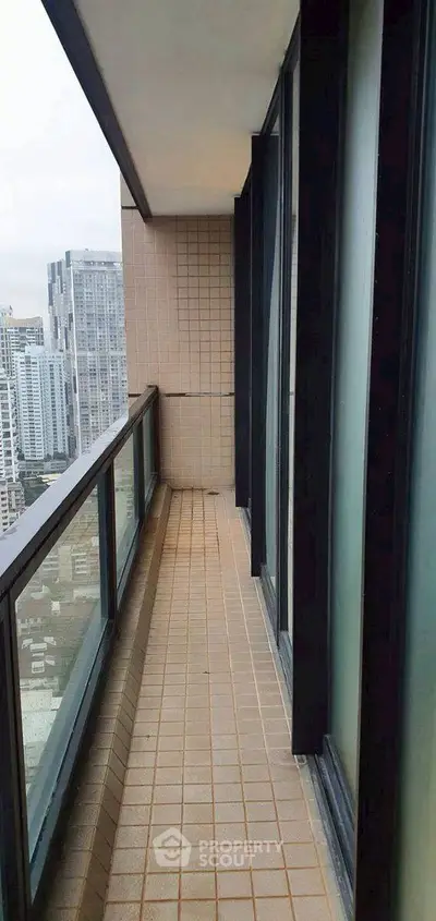 Spacious balcony with city view in modern high-rise building