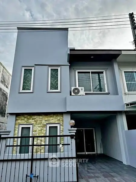 Modern two-story house with sleek facade and large windows