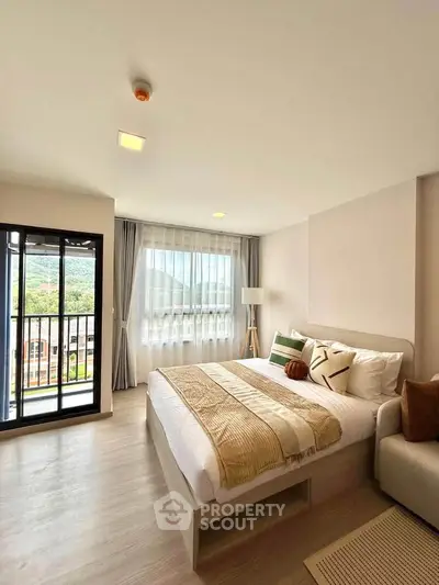Spacious bedroom with mountain view and modern decor in a luxury apartment.
