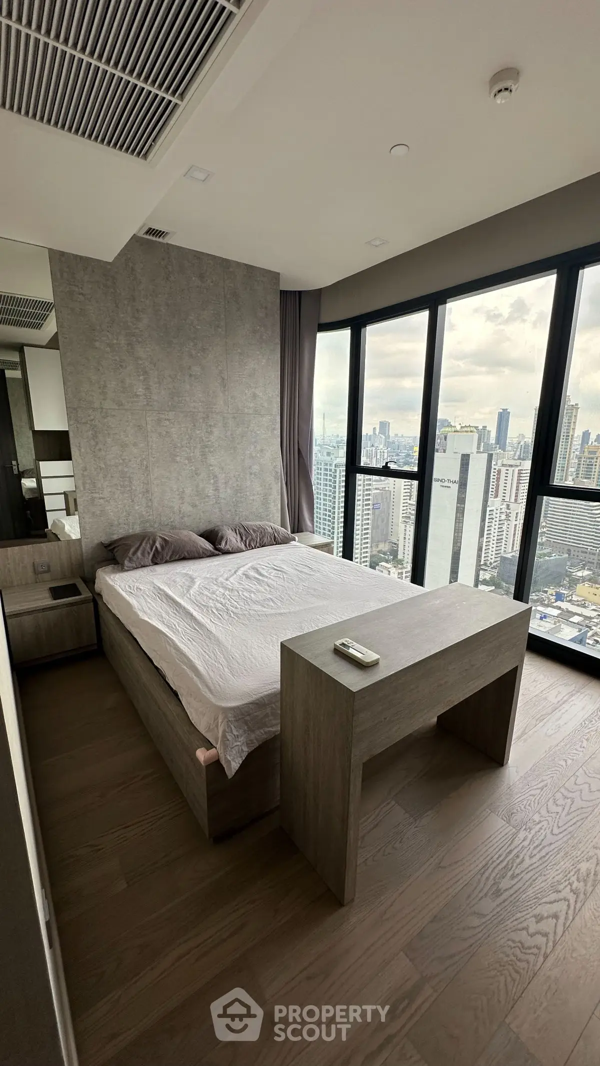 Modern bedroom with panoramic city view and stylish wooden furniture
