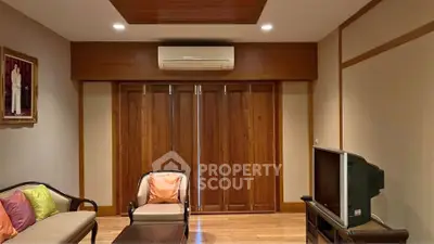 Cozy living room with wooden accents and modern air conditioning unit.