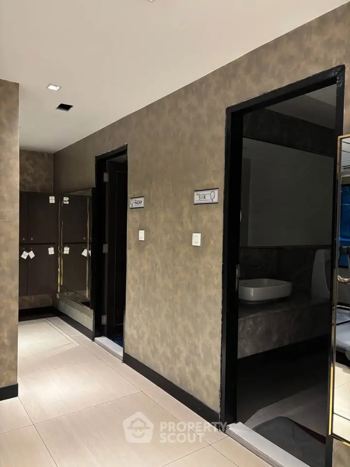 Modern building corridor with sleek restroom entrances and contemporary design.