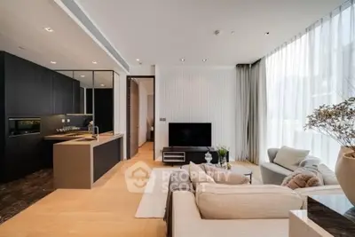 Luxurious modern living room with open kitchen, elegant decor, and floor-to-ceiling windows.