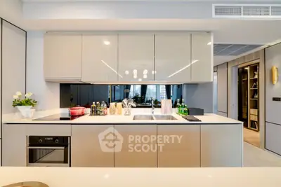 Modern kitchen with sleek cabinetry and built-in oven in luxury apartment