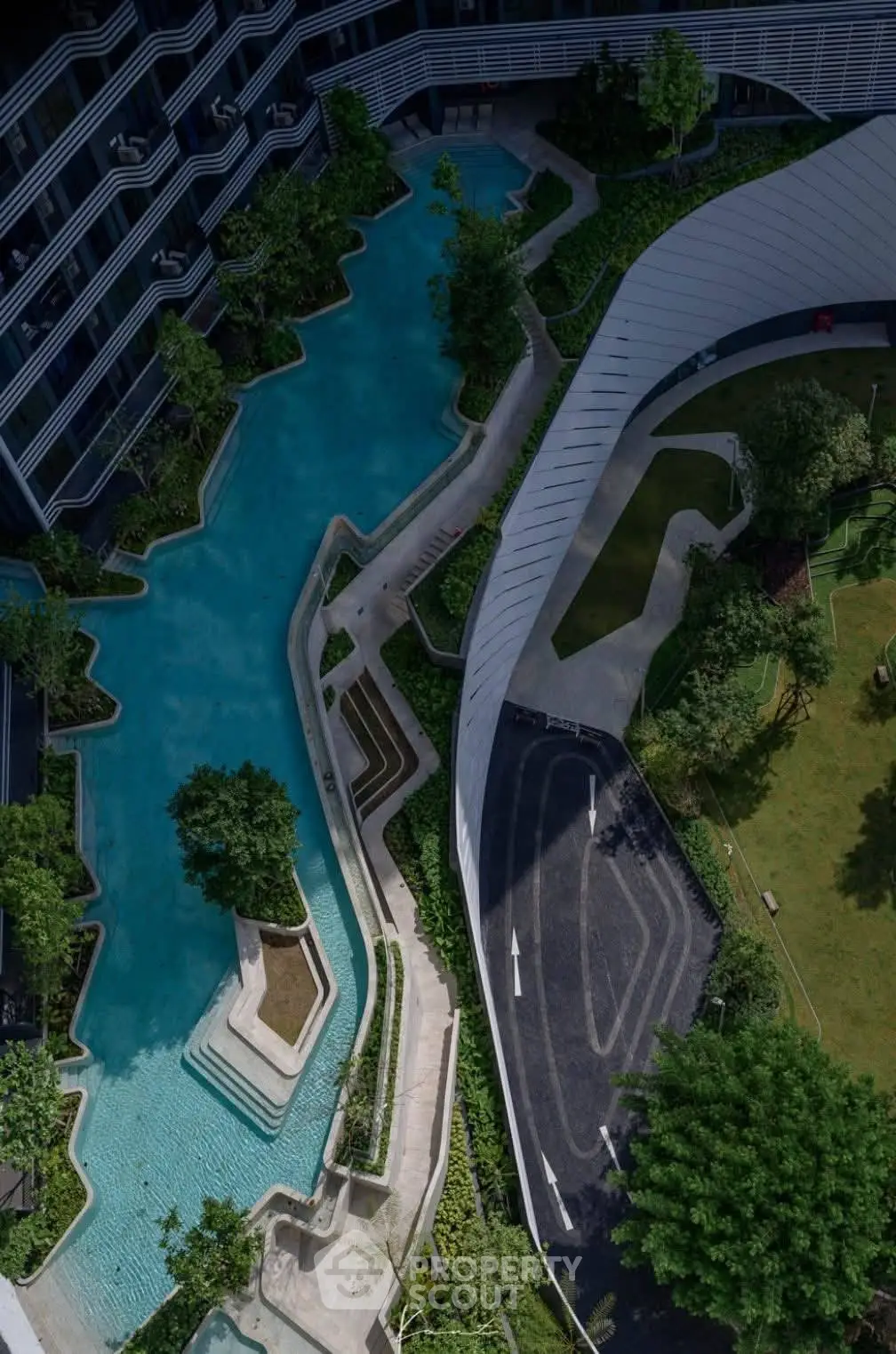 Luxurious modern building with stunning pool and landscaped garden view