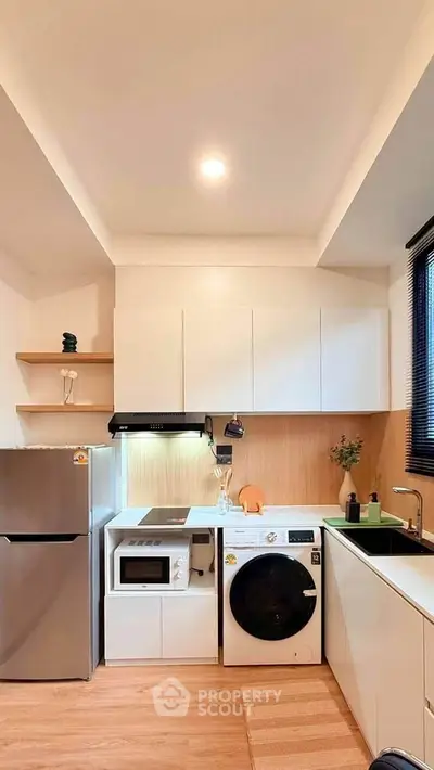 Modern compact kitchen with washing machine and sleek appliances