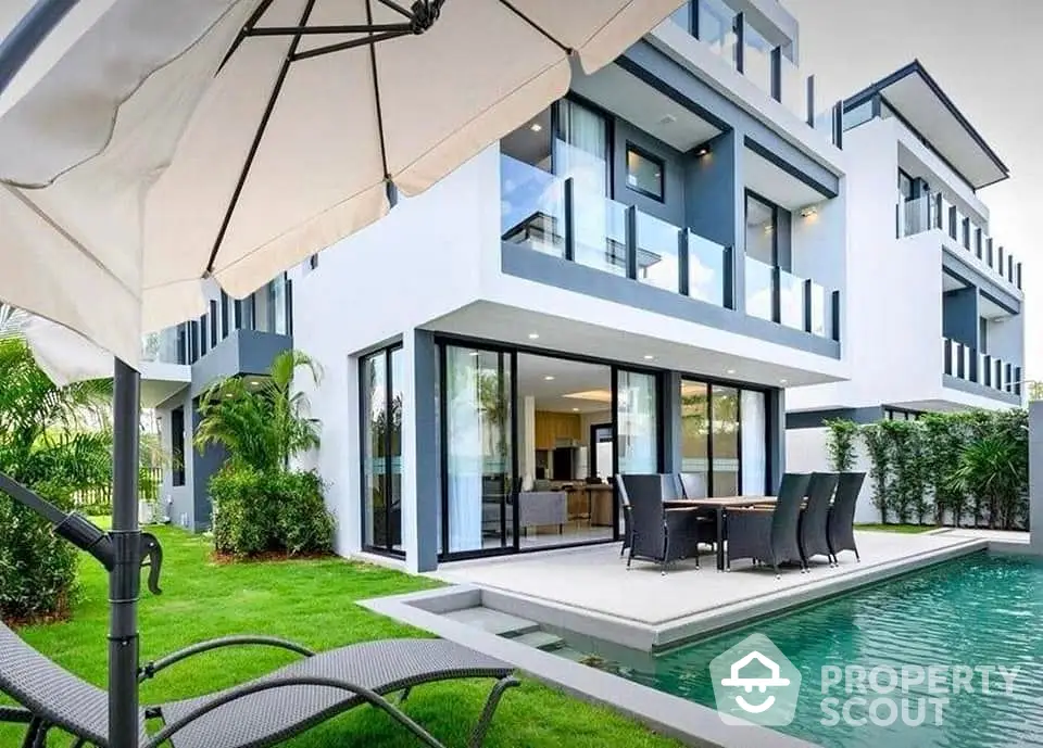 Luxurious modern villa with private pool and spacious outdoor seating area.