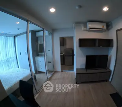 Modern apartment interior with bedroom and living room featuring sleek design and wooden flooring.