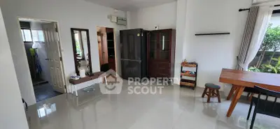 Spacious living area with modern furniture and garden view, perfect for family gatherings.