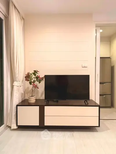 Modern living room with sleek TV stand and elegant decor, showcasing minimalist design and cozy ambiance.