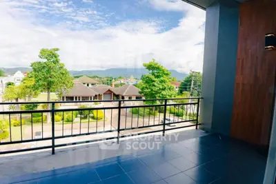 Spacious balcony with scenic view of lush greenery and residential area